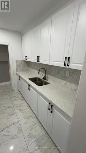 Brampton (Downtown Brampton) apartment for rent - A kitchen with white cabinets and marble countertops.