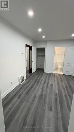 Brampton (Downtown Brampton) apartment for rent - A room with wooden flooring and a door on the left.