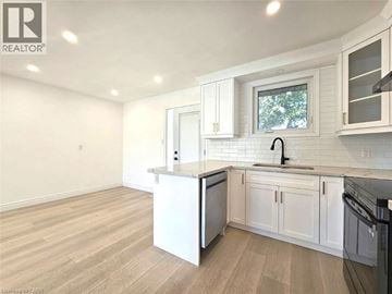 Cambridge apartment for rent - A kitchen with white cabinets and a window above the sink.