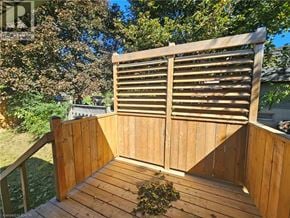 Cambridge apartment for rent - A wooden deck with a slatted fence and a pile of leaves on the floor.