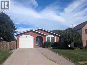 Cambridge apartment for rent - A red brick house with a white garage door.