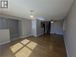 Cambridge apartment for rent - A spacious room with wooden flooring and a ceiling fan.