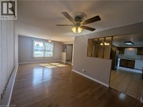 Cambridge apartment for rent - A spacious room with wooden flooring and a ceiling fan.