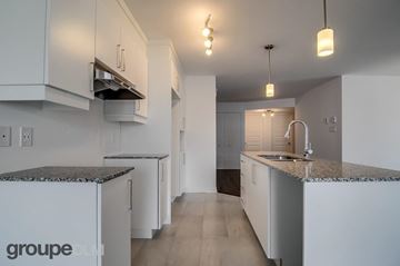 Gatineau (Aylmer) condo for rent - A kitchen with white cabinets and a granite countertop.