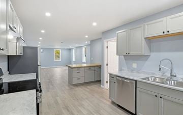 Palmer: Three Rivers apartment for rent - A modern kitchen with stainless steel appliances and wooden accents.