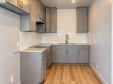 Los Angeles apartment for rent - A kitchen with a white tile backsplash and wooden floors.