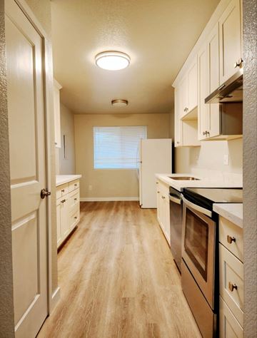 Edmonds apartment for rent - A kitchen with wooden floors and white appliances.
