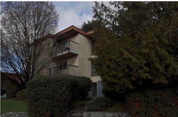 Vancouver apartment for rent - A house with a balcony and a tree in front.