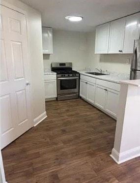 Louisville apartment for rent - A kitchen with white cabinets and a wooden floor.