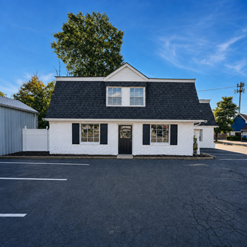 Louisville apartment for rent - A white house with a black roof and a black door.