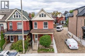 Hamilton apartment for rent - A red house with a white van parked in front.