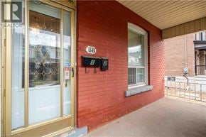 Hamilton apartment for rent - A red building with a glass door and a mailbox on the wall.