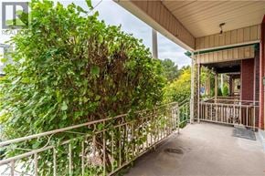 Hamilton apartment for rent - A balcony with a metal railing and a tree growing on it.