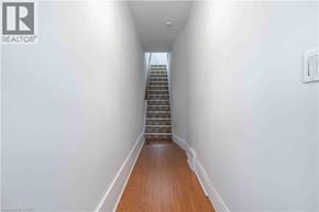 Hamilton apartment for rent - A long hallway with a staircase on the right side.