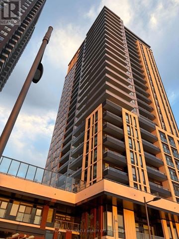 Vaughan (Concord) condo for rent - A tall building with a crane in the background.