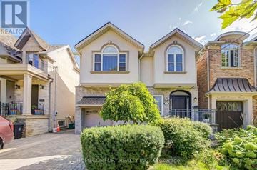 Toronto (Leaside) apartment for rent - A large, well-maintained house with a driveway and landscaping.