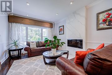 Toronto (Leaside) apartment for rent - A living room with a brown leather couch and a coffee table.