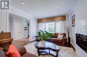 Toronto (Leaside) apartment for rent - A living room with a brown leather couch and a coffee table.