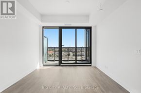 Toronto (Thorncliffe Park) condo for rent - A room with a large window and a view of the city.