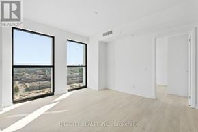 Toronto (Thorncliffe Park) condo for rent - A real estate listing image of a large, empty room with a view of a cityscape through the windows.