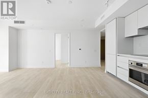 Toronto (Thorncliffe Park) condo for rent - A spacious kitchen with white cabinets and a stainless steel oven.