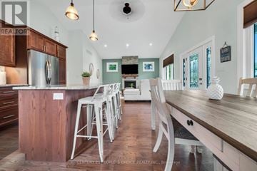South Bruce Peninsula apartment for rent - A kitchen with wooden cabinets and a long island with bar stools.