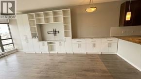 Richmond apartment for rent - A realtor's image of a kitchen with white cabinets and a wooden floor.