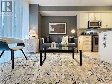 Toronto (Islington-City Centre West) townhouse for rent - A modern living room with a grey sofa and a glass coffee table.