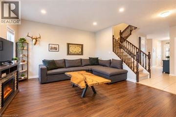 Waterloo townhouse for rent - A living room with a grey couch and a wooden coffee table.