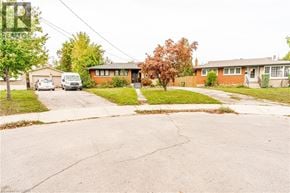 Hamilton apartment for rent - A red brick house with a white van parked in front.