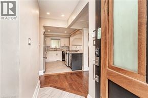 Hamilton apartment for rent - A modern kitchen with white cabinets and a wooden floor.