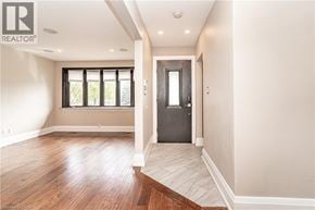 Hamilton apartment for rent - A room with a wooden floor and a door leading to another room.