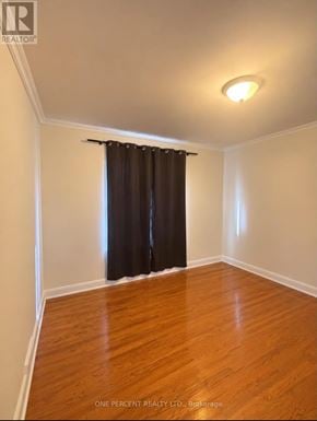 Toronto (Newtonbrook West) apartment for rent - A room with a brown curtain and wooden floor.