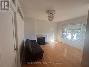 Toronto (Newtonbrook West) apartment for rent - A living room with a fireplace and a chandelier.