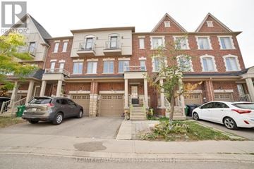 Brampton (Heart Lake East) townhouse for rent - A two-story brick house with a garage and a car parked in front.