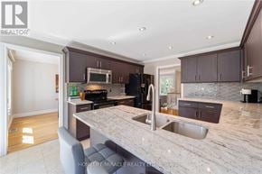 Clarington (Courtice) apartment for rent - A modern kitchen with granite countertops and stainless steel appliances.