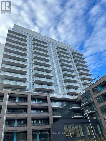 Newmarket (Central Newmarket) condo for rent - A tall building with a sign that says "HOMELIFE MIRACLE REALTY LTD" in front of it.