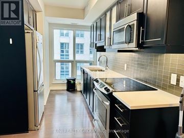 Ottawa condo for rent - A kitchen with black cabinets and a white countertop.