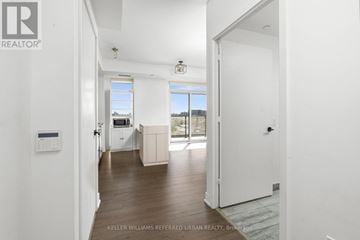 Toronto (Downsview-Roding-Cfb) condo for rent - A white door is open to a room with a kitchen in the background.