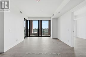 Toronto (Thorncliffe Park) condo for rent - A spacious room with a view of the city through large windows.