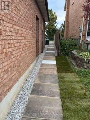 Markham (Aileen-Willowbrook) apartment for rent - A brick wall with a concrete pathway in front of it.