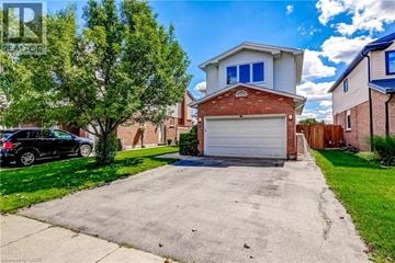 Waterdown apartment for rent - A house with a garage and a car parked in front.