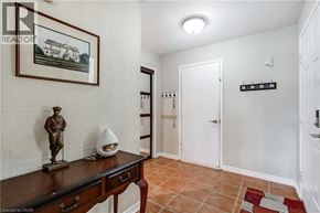Waterdown apartment for rent - A hallway with a statue and a framed picture on the wall.