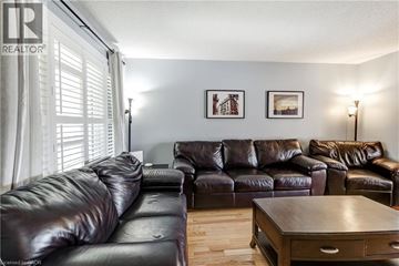 Waterdown apartment for rent - A living room with two leather couches and a wooden coffee table.