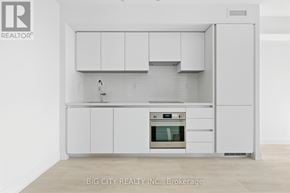 Toronto (Thorncliffe Park) condo for rent - A white kitchen with a sink and oven.