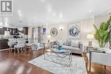 Toronto (Greenwood-Coxwell) apartment for rent - A well-lit living room with a glass coffee table and a white sofa.