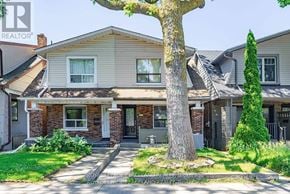 Toronto (Greenwood-Coxwell) apartment for rent - A house with a tree in front of it.