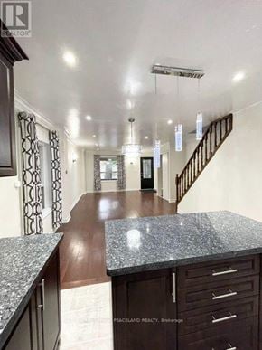 Toronto (Greenwood-Coxwell) apartment for rent - A spacious hallway with a staircase and a marble countertop.