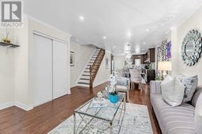 Toronto (Greenwood-Coxwell) apartment for rent - A living room with a glass coffee table and a grey couch.