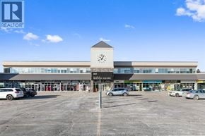 Lasalle apartment for rent - A large commercial building with a parking lot in front.